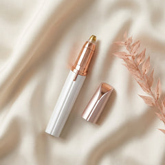 The Milara Brow Pen laid on cream silk with its cap