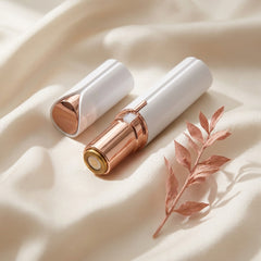 The Milara Face Shaver and cap laid on cream silk
